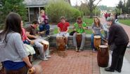 Students and Professor Lydia Hamessley demonstrate Ewe drumming.