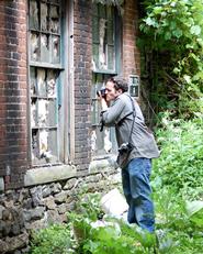 Greg Huffaker '09 takes a picture of a Utica warehouse