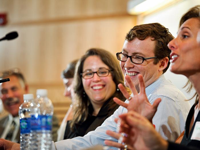 Professor of Biology Herm Lehman, Alysia Mihalakos '01 and James Liebow '13 listen to Karen McDonnell '91 make comments during a panel on Public Health Context and Challenges. PHOTO: NANCY L. FORD