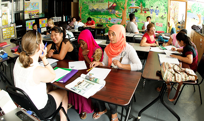 Members of the Levitt Center research group help refugees at the Mohawk Valley Refugee Center learn to read and write English. PHOTO: NANCY L. FORD